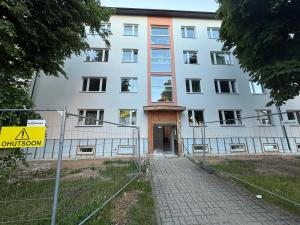 a large white building with a fence in front of it at Stay in Old Town in Võru +1 photo