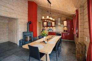 a kitchen with a table and chairs and a stove at Chalet Hahnenklee in Goslar