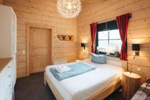 a bedroom with a bed in a wooden room at Chalet Hahnenklee in Goslar