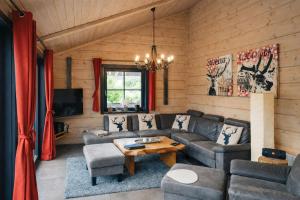 a living room with a couch and a table at Chalet Hahnenklee in Goslar