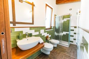 a bathroom with a sink and a toilet at The Chalet, guest house in Agerola +95 photos