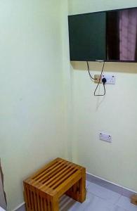 a room with a wooden bench on a wall at Wisny Guest House in Kasoa