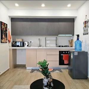 a kitchen with stainless steel appliances and a table at Pinnacle suites in Nairobi