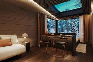a bedroom with a bed and a desk with a window at ALVA Resort in Rovaniemi