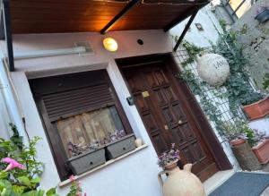 a front door of a house with potted plants at L' anfora Locazione Turistica in Terni