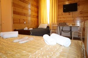 a bedroom with a bed with towels on it at MAKO in Racha in Ambrolauri