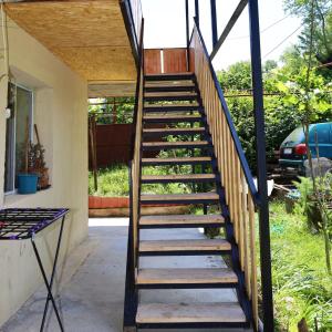 a set of stairs leading up to a house at MAKO in Racha in Ambrolauri