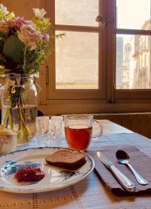 a plate of toast and a cup of tea on a table at Le Bel Angle in Arles
