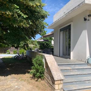 a wooden bench on a porch of a house at Maison familiale dans le var in Brignoles