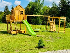 a playground with a slide and a play structure at Ski Mountain Apartamenty - Plac zabaw - Dmuchaniec - Plac zabaw - Wypożyczalnia rowerów elektrycznych E-Bike Białka in Białka Tatrzańska