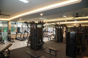 a gym with rows of exercise equipment in a room at Shankara D'Uma in Ubud