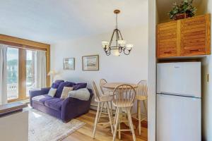 a living room with a purple couch and a table at Timber Ridge 504B in Silverthorne