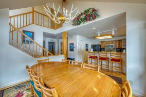 a dining room and kitchen with a wooden table at Fairway Getaway in Copper Mountain