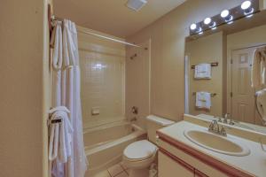 a bathroom with a sink and a toilet and a mirror at Fairway Getaway in Copper Mountain +26 photos