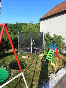 a backyard with a swing set and a trampoline at Stefke 2 in Lučani