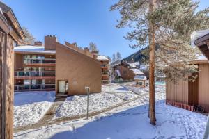 a building in the snow with a tree at Wild Irishman 1080 in Dillon