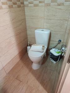a bathroom with a white toilet in a room at red caravan in Nea Potidaea