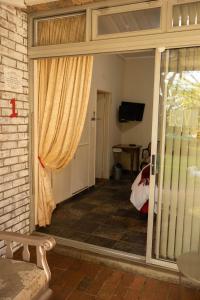 a room with a sliding glass door with a window at Blessings Guesthouse in Newcastle