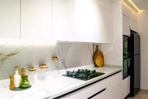 a kitchen with white cabinets and a stove top oven at Dar Mustapha in Tunis