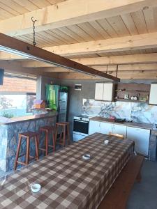 a kitchen with a table and some chairs in it at Stefke 2 in Lučani