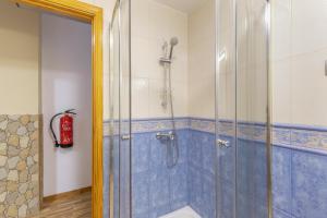 a shower in a bathroom with blue tiles at Las Sirenas 2 in Las Palmas de Gran Canaria +16 photos