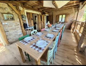 a long wooden table with chairs in a room at Banja Luka house - Casa Rustica in Banja Luka