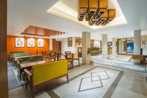 a dining room with a table and chairs at Tripli Hotels M & Resort in McLeod Ganj