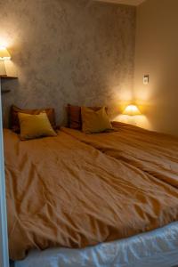 a large bed in a room with two pillows on it at Mountain View Apartment, Free Parking, Hiking Nearby in Ålesund