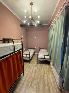 a room with three bunk beds and a ceiling at Hostel Room 110 in Tbilisi City +16 photos
