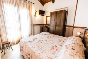 a bedroom with a bed and a large window at Agriturismo La Baita in Agerola