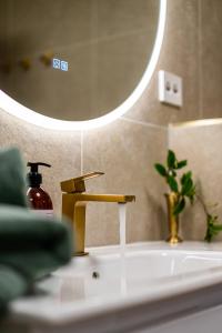 a bathroom sink with a faucet and a mirror at Mountain View Apartment, Free Parking, Hiking Nearby in Ålesund +35 photos