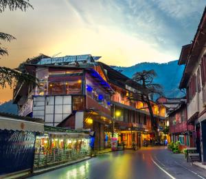 a street in an asian city at sunset at Tripli Hotels M & Resort in McLeod Ganj