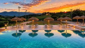 a pool with chairs and umbrellas at a resort at Agriturismo AgrileisureTime in Spoleto