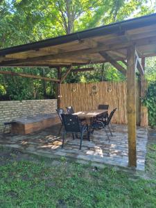 a patio with a table and chairs under a pavilion at Avalon Mali Stapar in Mali Stapar