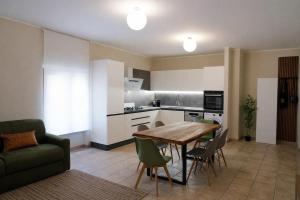 a kitchen and dining room with a table and chairs at Fiuggi Terme Bonifacio Apartment in Fiuggi
