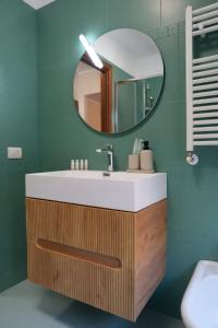 a bathroom with a sink and a mirror at Fiuggi Terme Bonifacio Apartment in Fiuggi +16 photos