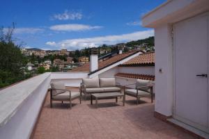 a balcony with chairs and a view of a city at Fiuggi Terme Bonifacio Apartment in Fiuggi