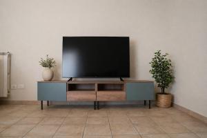 a flat screen tv sitting on top of a entertainment center at Fiuggi Terme Bonifacio Apartment in Fiuggi