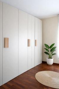 a room with white cabinets and a potted plant at Fiuggi Terme Bonifacio Apartment in Fiuggi