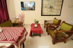 a living room with a table and chairs and a table sidx sidx sidx at SM Cottage in Mangalore