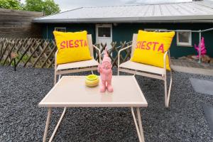 a doll sitting on a table in front of two chairs at The Great View Sauna & more in Harscheid +49 photos