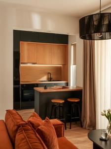 a living room with a couch and a kitchen at Nostos - Luxury Apartment in Agrinio in Agrinio