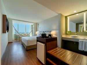 a hotel room with a bed and a sink at Grand Mercure Rio de Janeiro Copacabana in Rio de Janeiro +198 photos