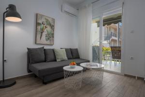 a living room with a couch and a table at SLV Danai 7 Apartments in Ofrínion