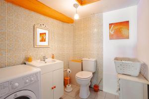 a bathroom with a washing machine and a sink at Gite Romantique de Type Charentais in Le Thou +13 photos