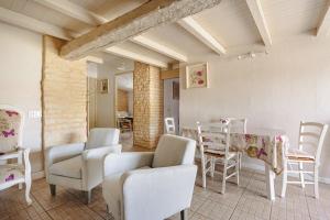 a living room with a table and chairs at Gite Romantique de Type Charentais in Le Thou