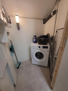 a small laundry room with a washing machine in it at Betting 2 in Merlebach