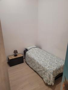 a bedroom with a bed and a night stand at Betting 2 in Merlebach