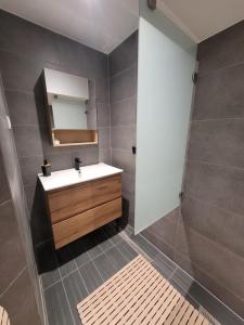 a bathroom with a sink and a mirror at Betting 2 in Merlebach +1 photo