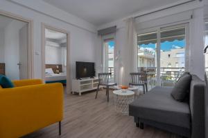 a living room with a couch and a tv at SLV Danai 7 Apartments in Ofrínion
